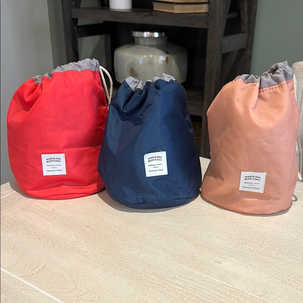 Set of Three Travel Drawstring Bags in Red, Navy, and Peach